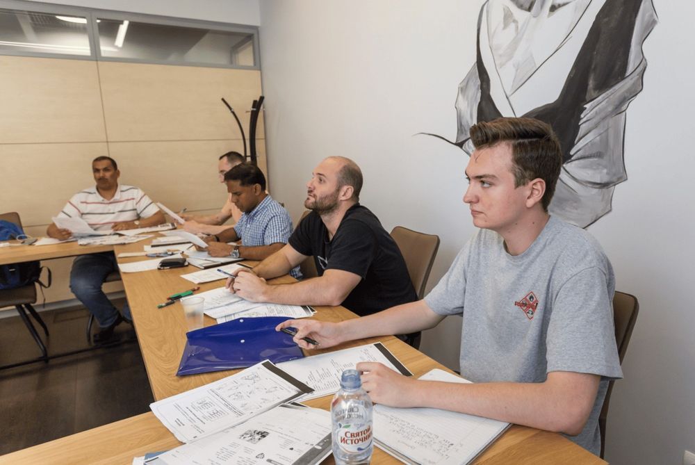 Adult students in class at a shared table