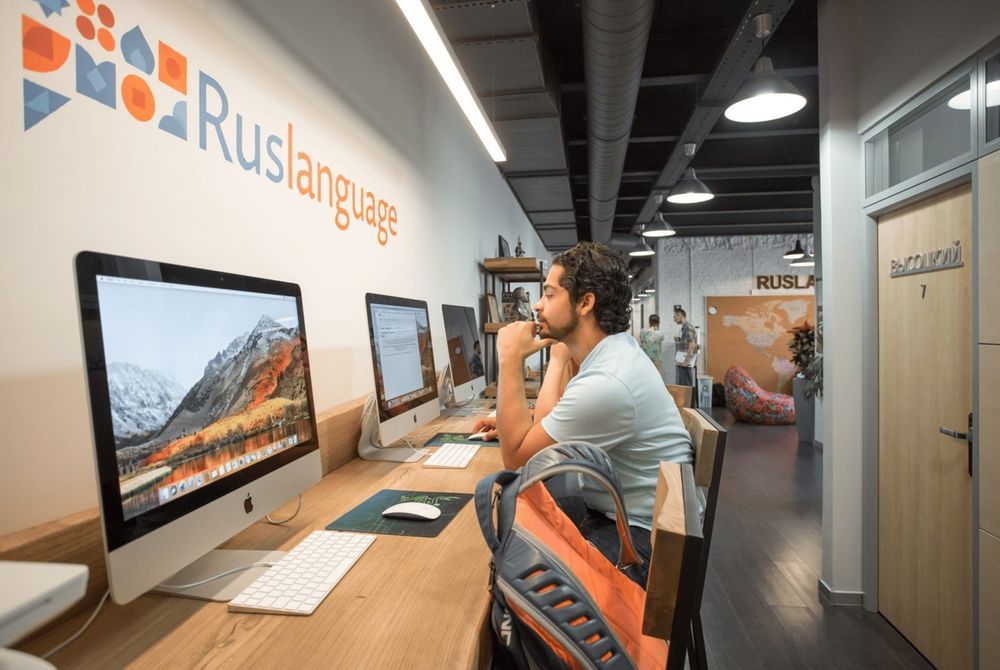 A student at a computer in the Ruslanguage school hallway